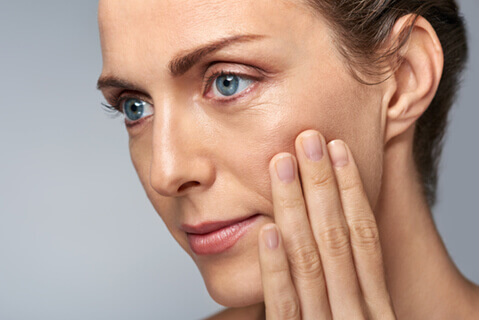 Attractive woman touching her cheek