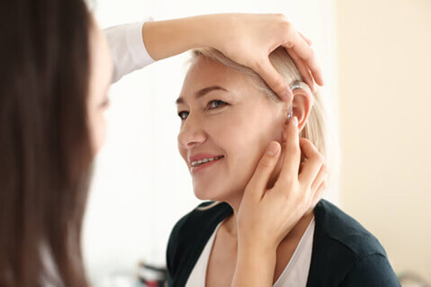 Woman having her ear examined