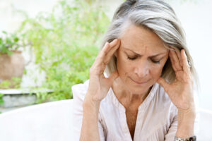 woman holding her head from headache